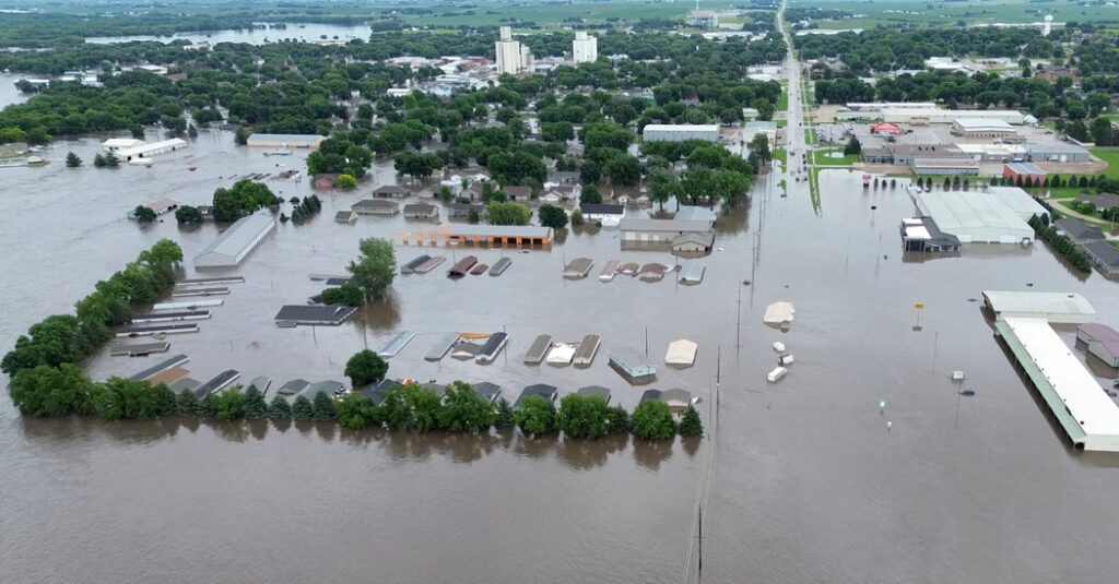 Workers Rush To Strengthen Levees As Floodwaters Engulf Midwest Town
